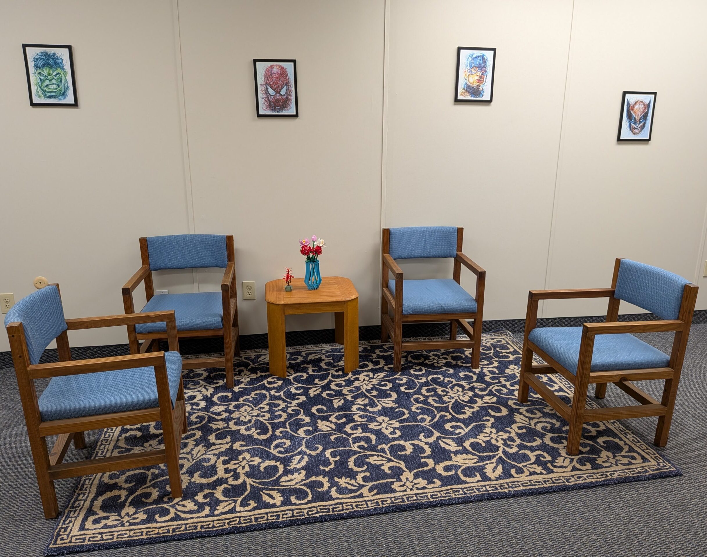 Front office with blue chairs and art on walls